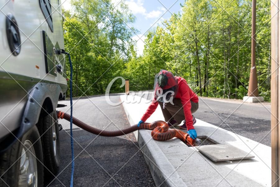 connecting the hosepipe into a water tank to empty the septic tank of an RV